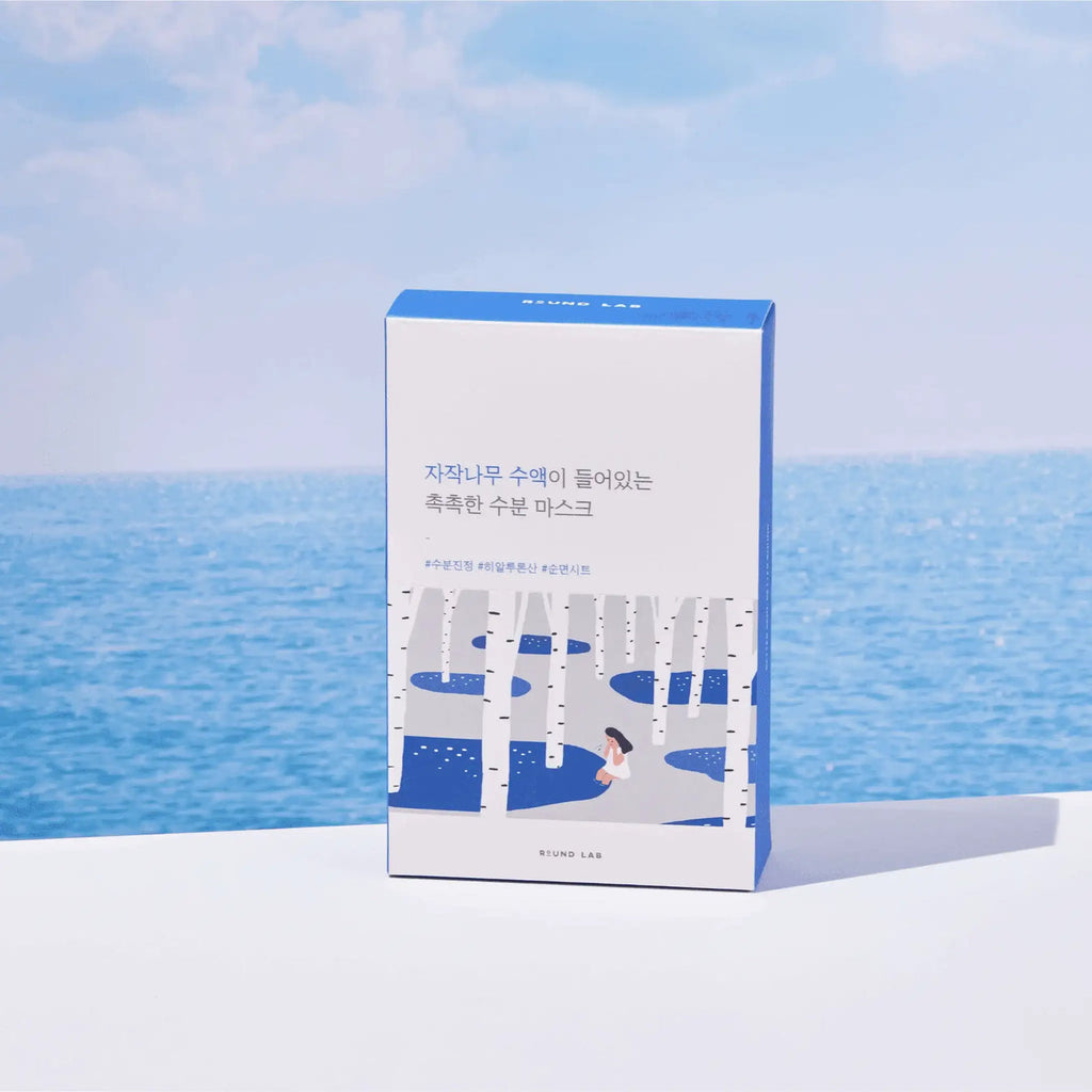 Product packaging with blue and white design against a blue sky and ocean background