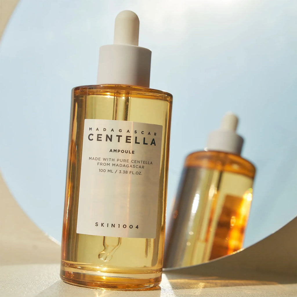 Skincare bottle labeled 'Madagascar Centella Ampoule' with a dropper on a light background