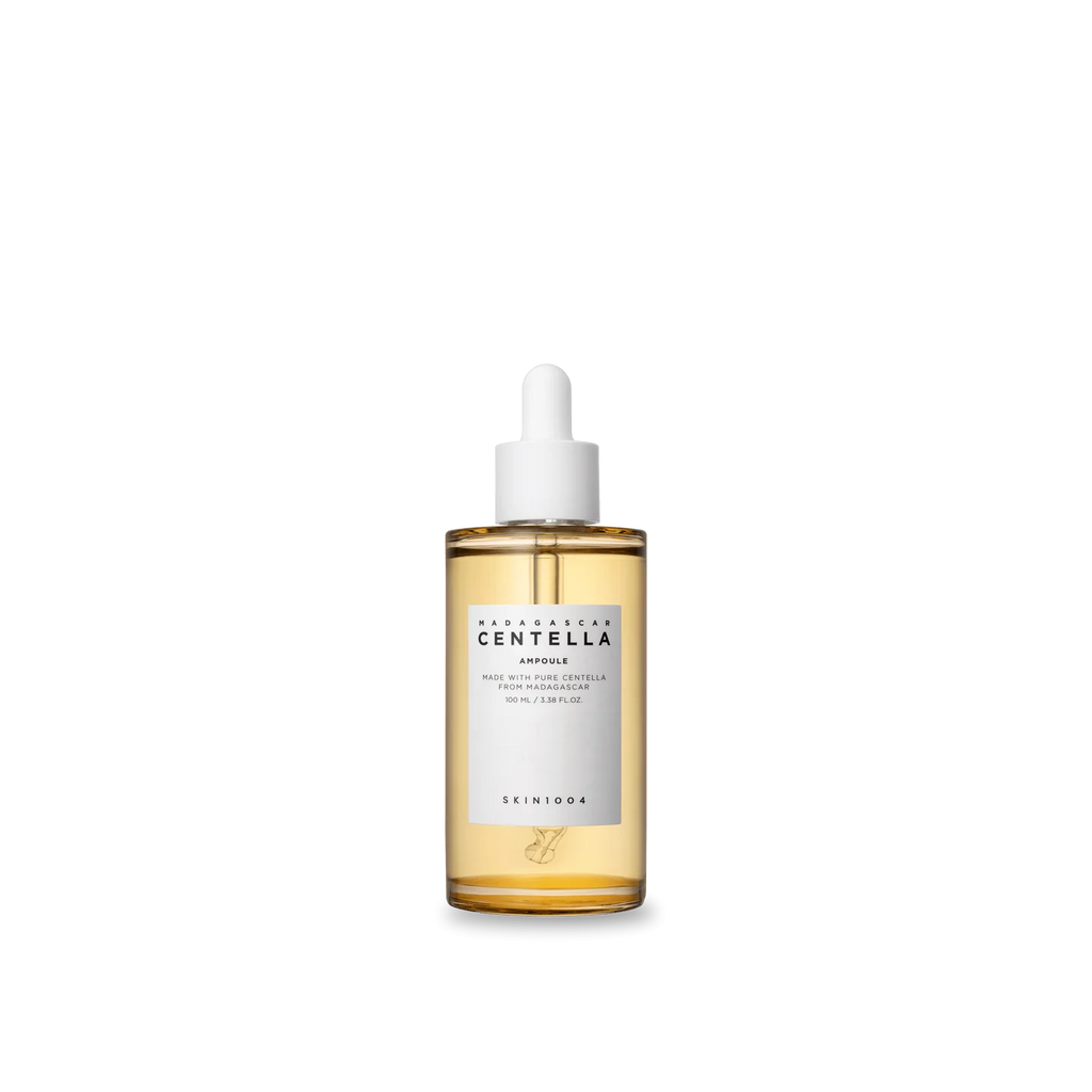 Skincare serum bottle with a white cap on a white background