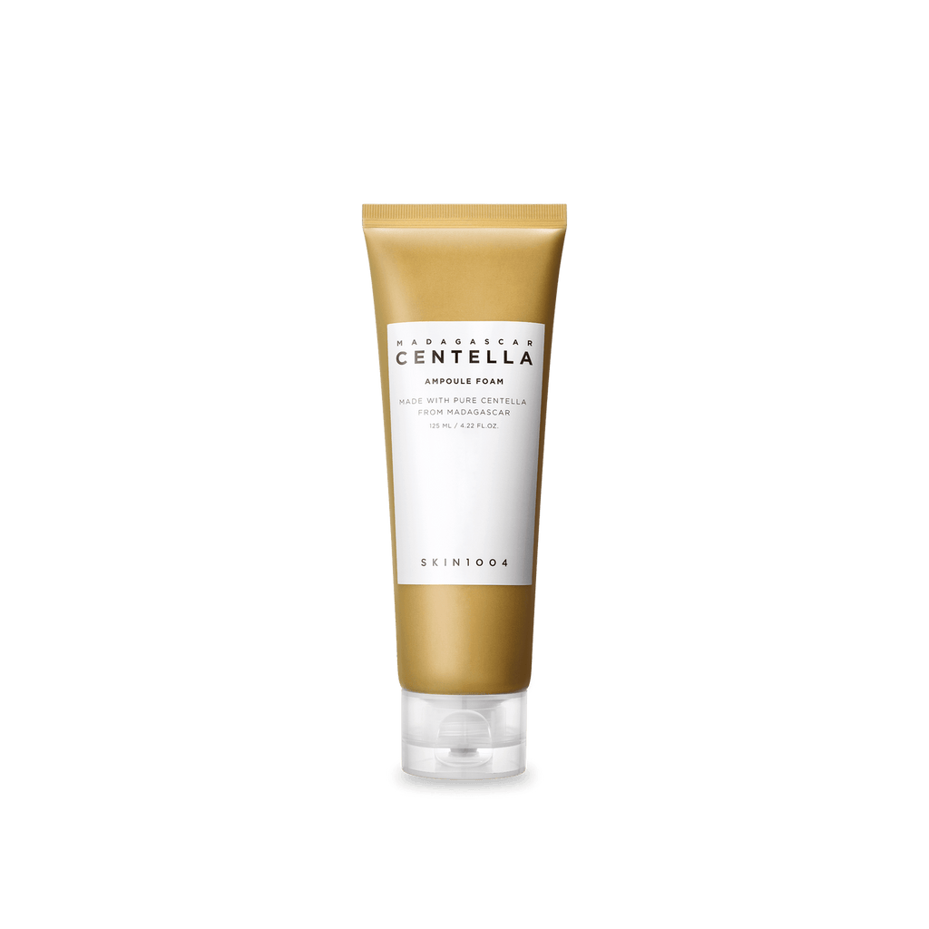 Skincare tube with gold and white design on a green background