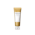Skincare tube with gold and white design on a green background