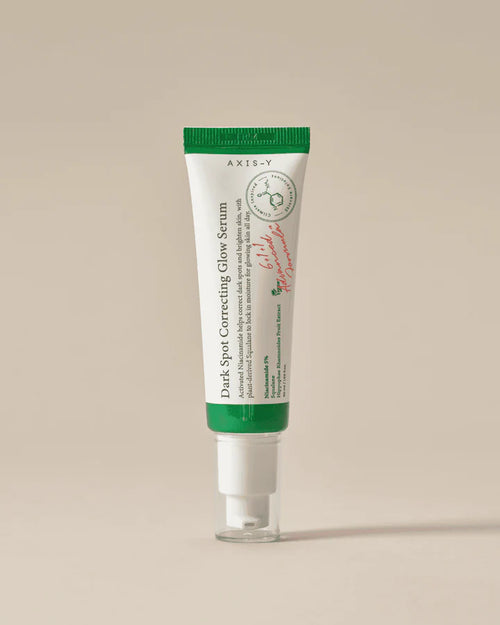 Tube of Axis-Y Dark Spot Correcting Glow Serum on a beige background