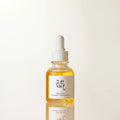 Skincare serum bottle with dropper on a light beige background