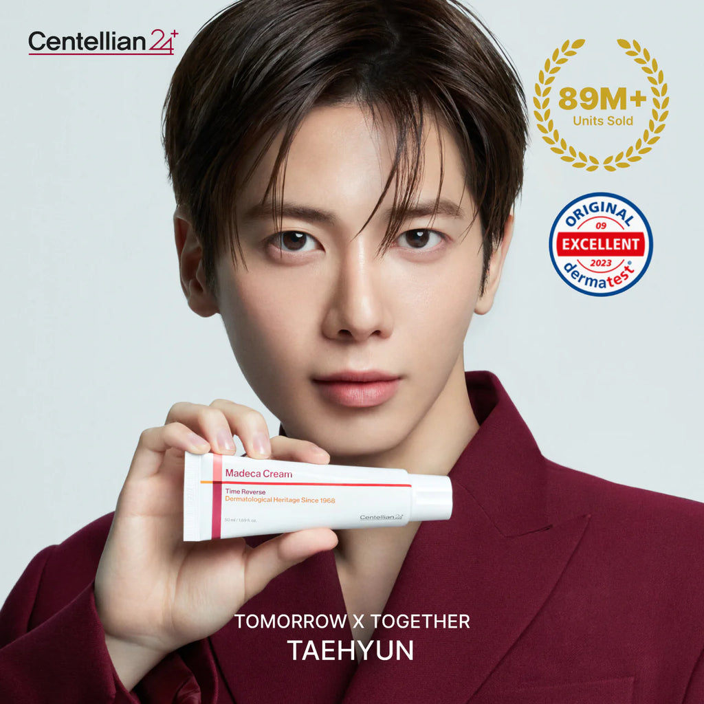 Person holding a tube of Centellian2+ Madeca Cream with brand logos and text on a light gray background