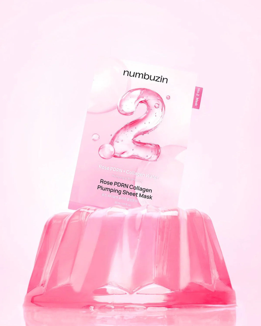 Pink sheet mask with 'numbuzin' branding on a light pink background
