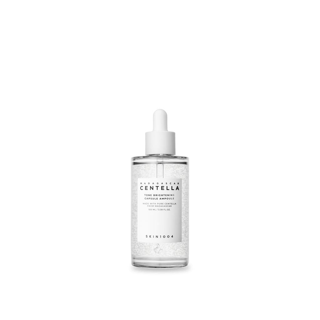 Skincare dropper bottle with Centella Asiatica on a green background