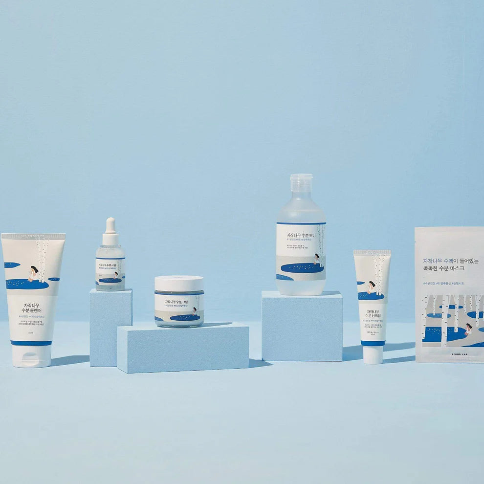 Collection of skincare products on a light blue background