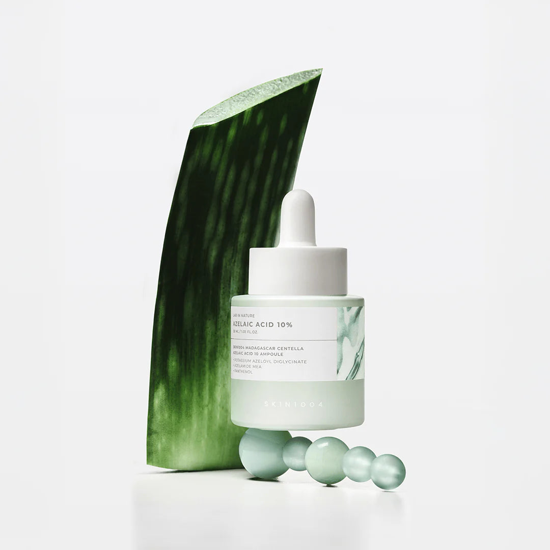 Skincare product with aloe vera leaf and dropper on a white background