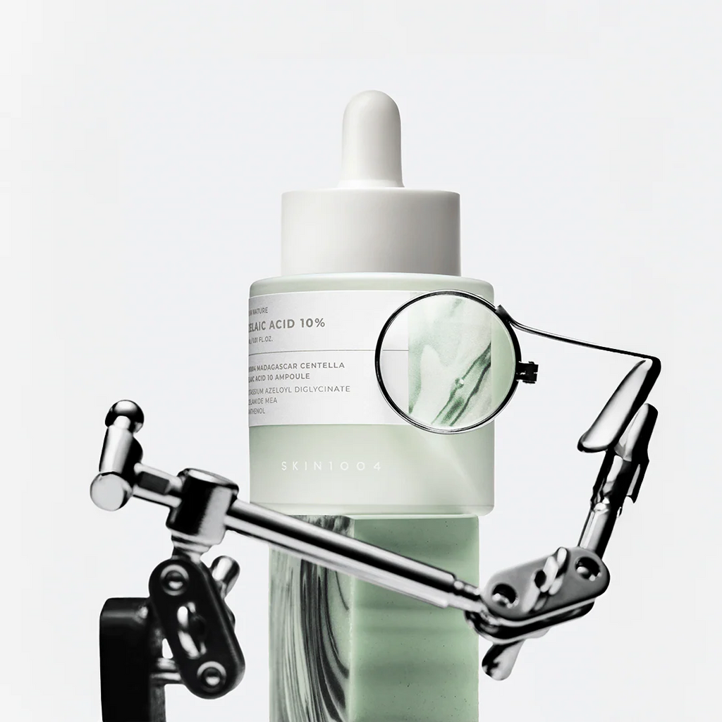 Skincare dropper bottle with a magnifying glass on a white background