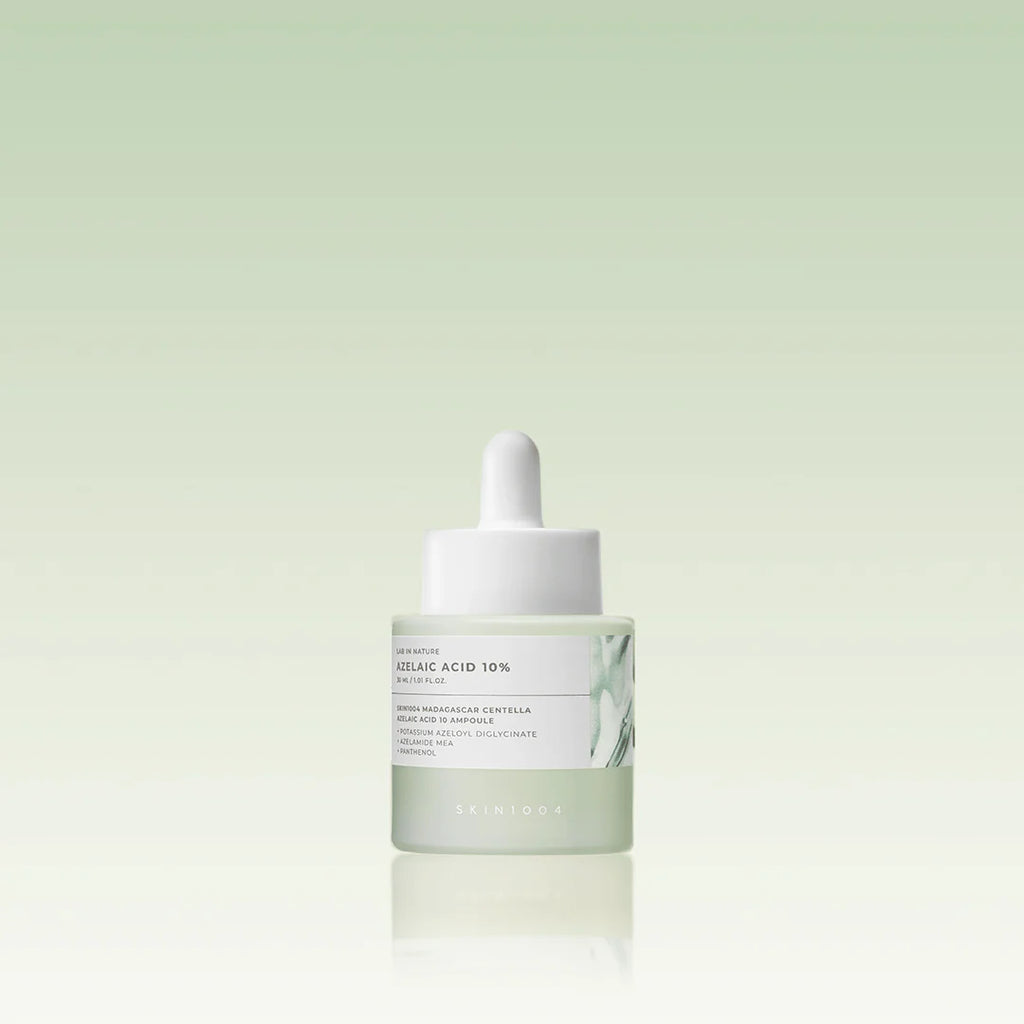 Skincare dropper bottle with a white cap on a light green background
