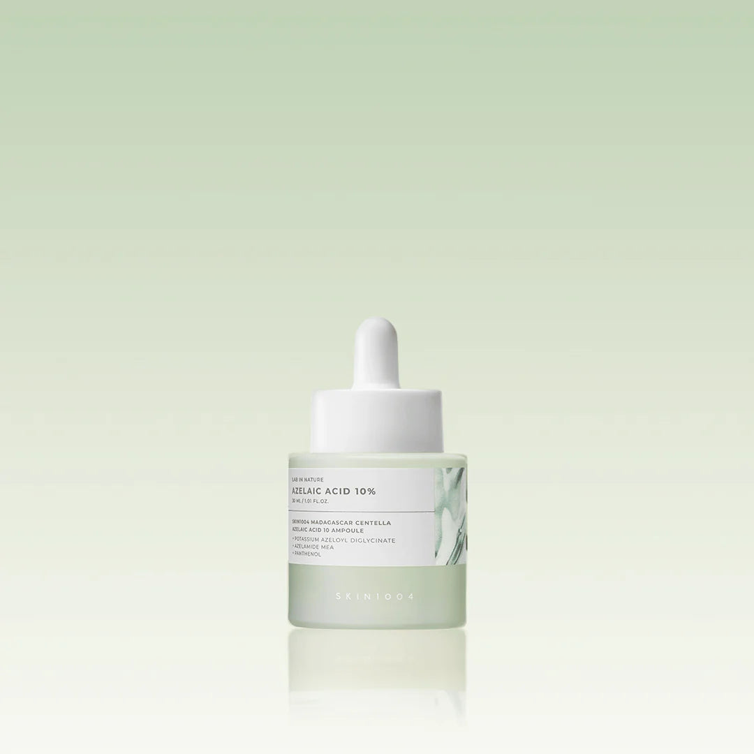 Skincare dropper bottle with a white cap on a light green background