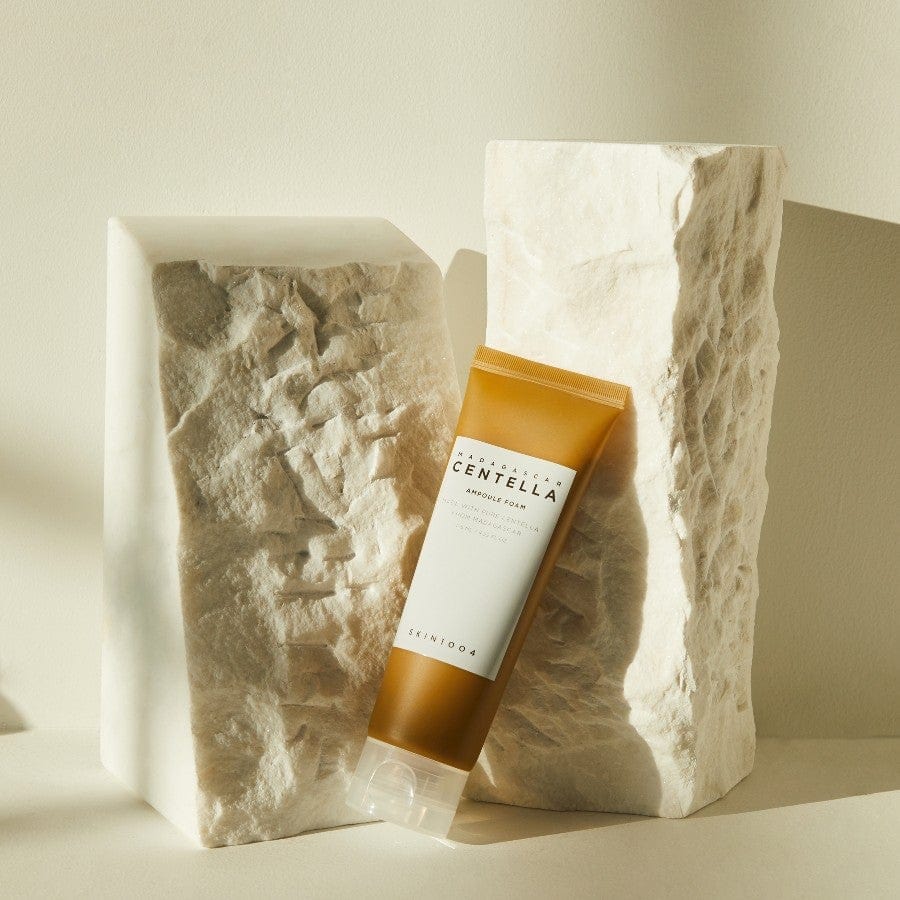 Skincare product with 'CENTELLA' label in a stone-like container on a neutral background