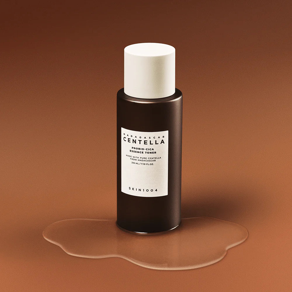 Skincare bottle with a white cap on a brown background